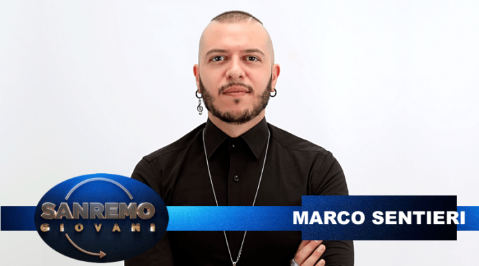 Marco Sentieri con maglia nera con la scritta Sanremo Giovani, partecipante al prossimo festival al Teatro Ariston