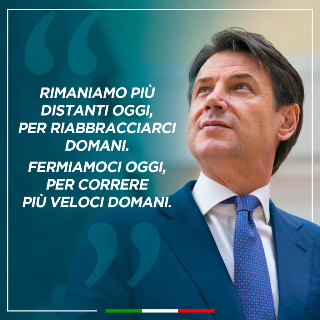 negozi aperti e negozi chiusi il premier Conte con vestito blu camicia bianca e cravatta azzurra guarda verso l'alto 