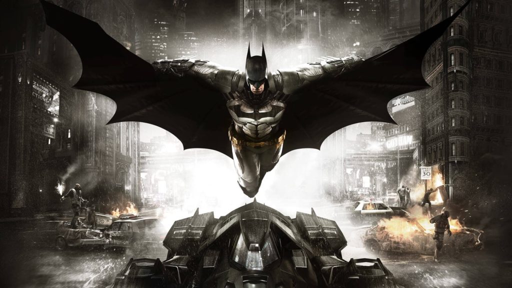 il supereroe Batman in volo sopra la batmobile, con le ali aperte, dietro di lui la città in fiamme