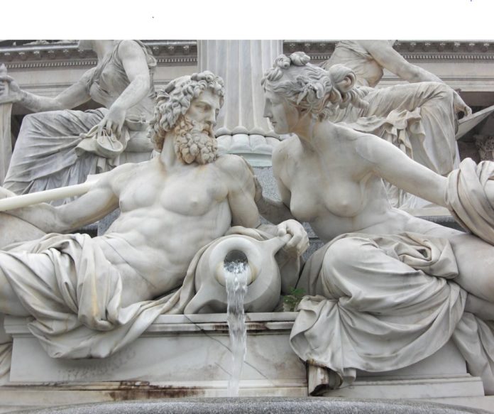 Da Torino a Vienna - La fontana davanti al parlamento viennese con un uomo e una donna seminudi con una brocca tra loro che versa acqua e i due visi che si guardano