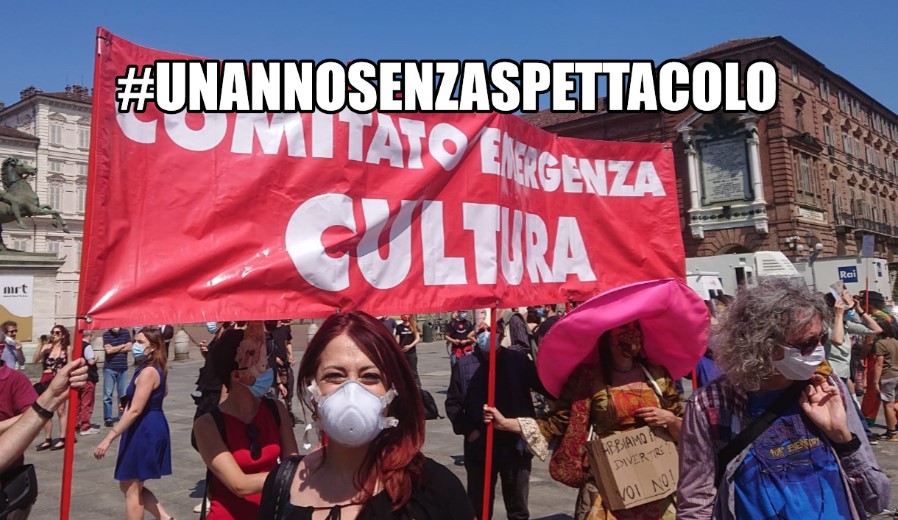 #unannosenzaspettacolo - lavoratori dello spettacolo #unannosenzaspettacolo in una manifestazione in piazza con uno striscione rosso con su scritto "comitato emergenza cultura"