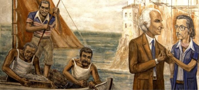 Diamante Murales - un murales raffigurante dei pescatori intenti a tirare su delle reti e sulla parte destra della foto, due uomini di profili che parlano, sono vestiti elegantemente, con giacche e sullo sfondo sono dipinti faraglioni e il mare