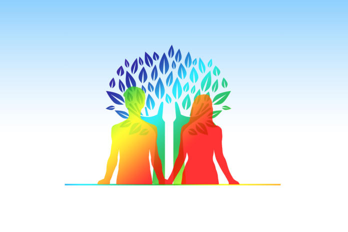 Vitality, benessere, salute, prevenzione, equilibrio. Il corpo di un uomo e una donna di colore arancione e giallo mentre si tengono per mano. Sullo sfondo un albero stilizzato colorato di verde, azzurro e viola.