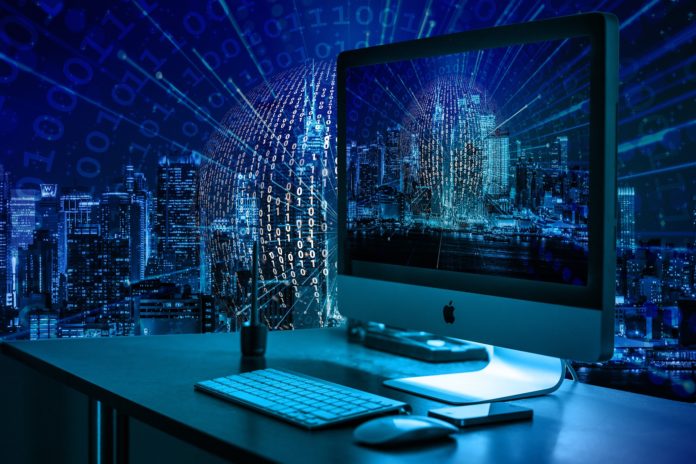 diritto all'oblio - un computer con l'immagine di manhattan sullo schermo e dietro una vwetrata con la stessa vista. utta l'immagine è blu