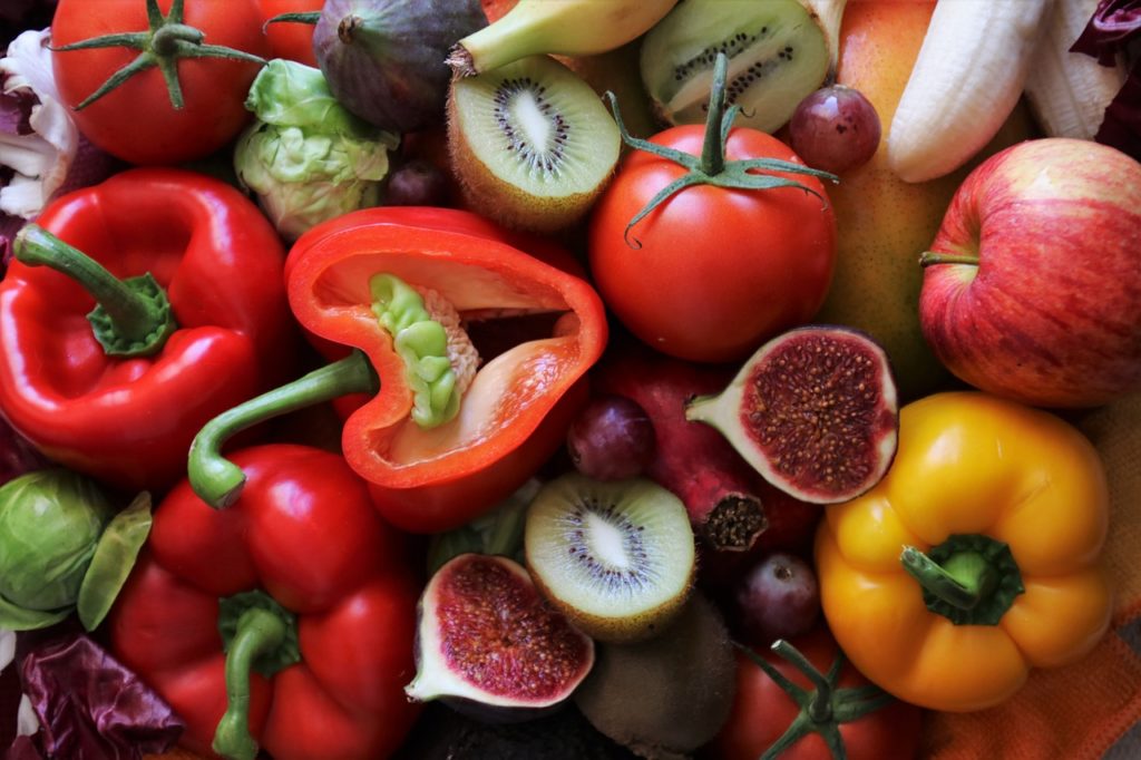 Insieme di peperoni, banane, fichi, kiwi e pomodori. Alcuni degli alimenti che contengono la vitamina C
