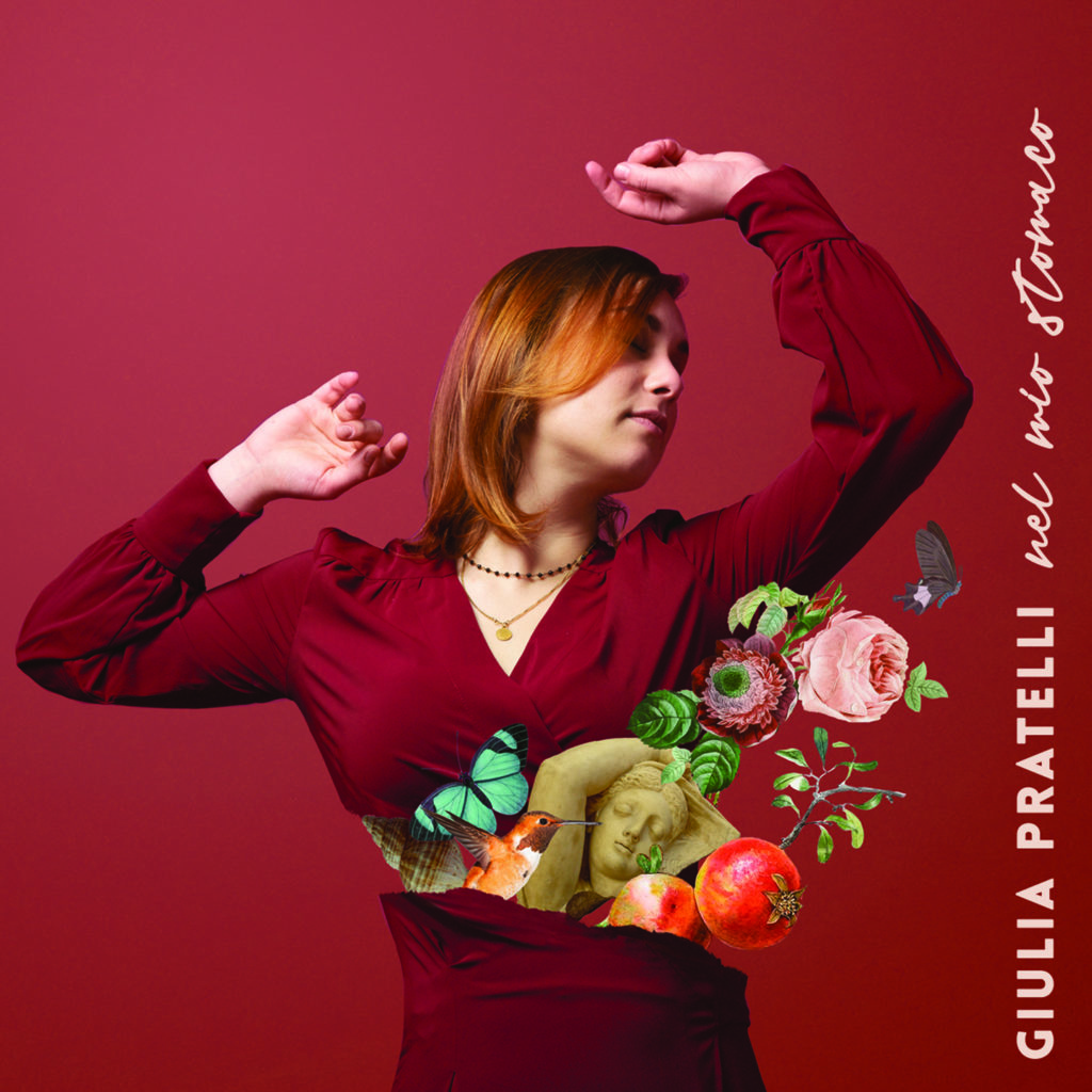 giulia praatelli - la copertina del nuovo album che la ritrae in primo piano, vestita di rossso, capelli rossi e braccia alzate