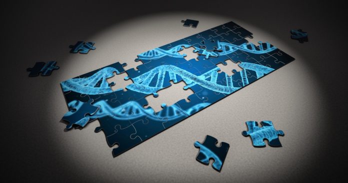 un puzzle incompleto, raffigurante la struttura ad elica del DNA, blu e nero, e alcune tessere del puzzle sparse sul tavolo