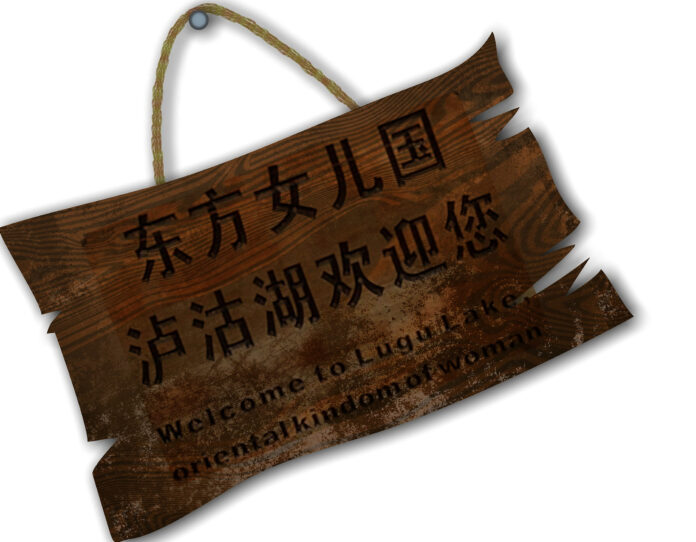 benvenuti nel paese delle donne è la scritta in cinese e in inglese che c'è su questo cartello di legno appeso ad un chiodo , messo di sbieco