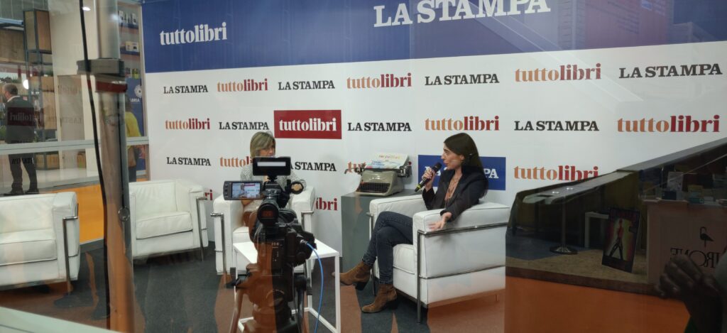 un momento di intervista durante il Salone due perosne sedute in uno stand RAI