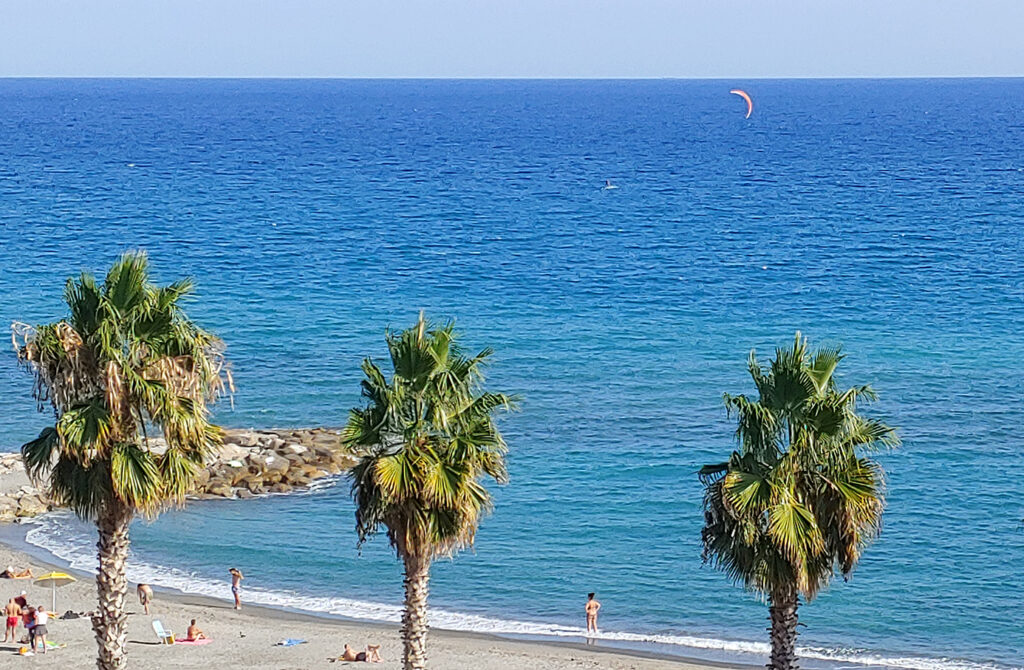 lIGURIA - UNA VEDUTA PANORAMICA DEL MARE AL TRAMONTO CON LE PALME SULLA SPIAGGIA