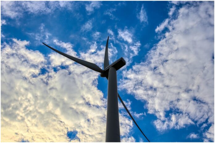 indipendenza energetica - nella foto una pala eolica con sopra un cielo blu con nuvole