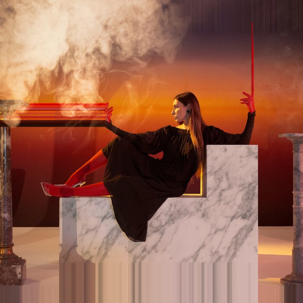 golden rain - la copertina del nuovo albumk che raffigura una donna vestita di scuro sdraiata su un blocco di marmo bianco