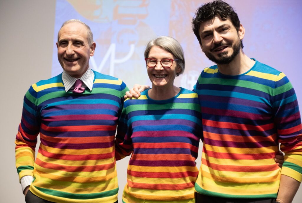 tre persone i curatori artisti con maglie arcobaleno
