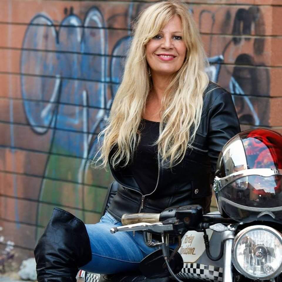 anima stanca - lina savonà, lunghi capelli biondi, è seduta sul sellino di una moto