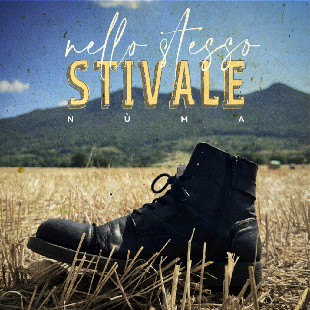 nùma - la copertina del nuovo singolo che raffigura uno scarponcino modello anfibio, in un campo di grano appena tagliato