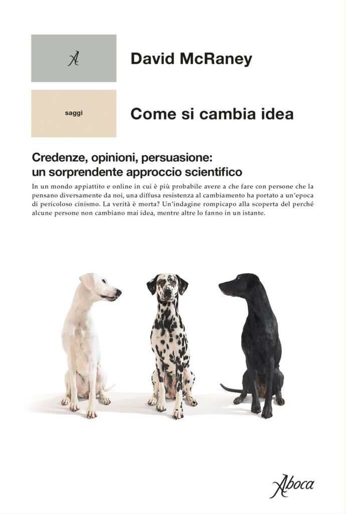 copertina del libro di David McRaney come si cambia idea tra cani al centro un dalmata a destra uno nero e a sinistra uno bianco