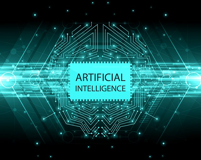 Artificial intelligence scritta con turhese fosfrescente su fondo nero con migliaia di connessioni intorno. Immagine licenza CC