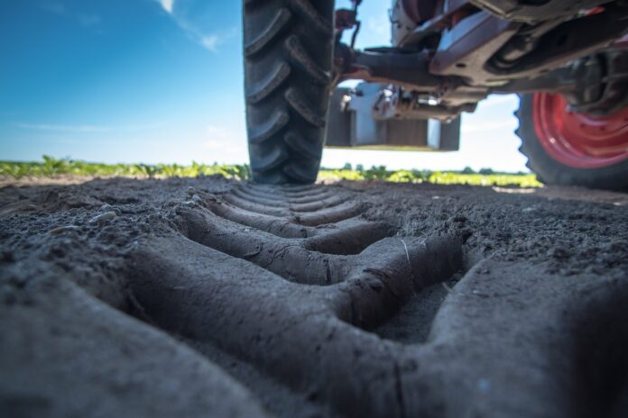 la protesta degli agricoltori - primo piano sulla ruota di un trattore e sul segno nel terreno che lascia passando