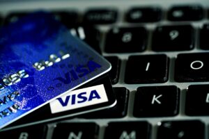 pagamenti cntactless . in primo piano l'angolo di due carte di credito con la scritta "visa" appoggiate sulla testiera di un pc