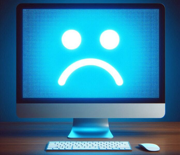 aggiornamento windows 11 problemi - nella foto uno schermo di computer tutto blu con uno smile triste bianco al centro