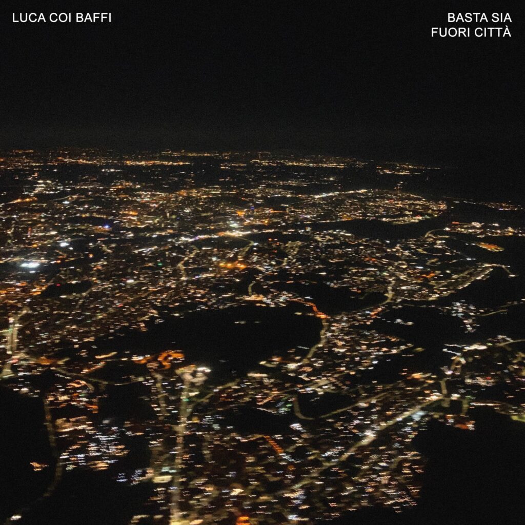 luca coi baffi - l copertina del nuovo singolo che raffigua una città illuminata di notte