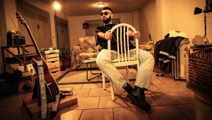 garenna seduto su una sedia di legno bianco all'interno di una sala con degli strumenti